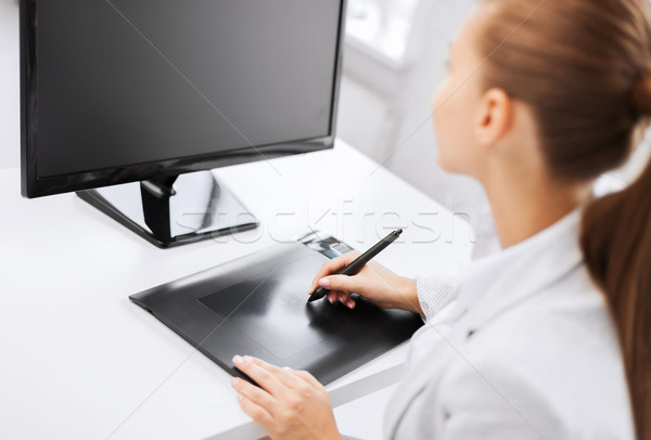 businesswoman with drawing tablet in office Stock photo © dolgachov