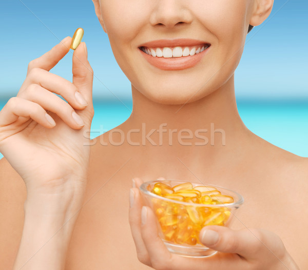 Stock photo: beautiful woman with omega 3 vitamins