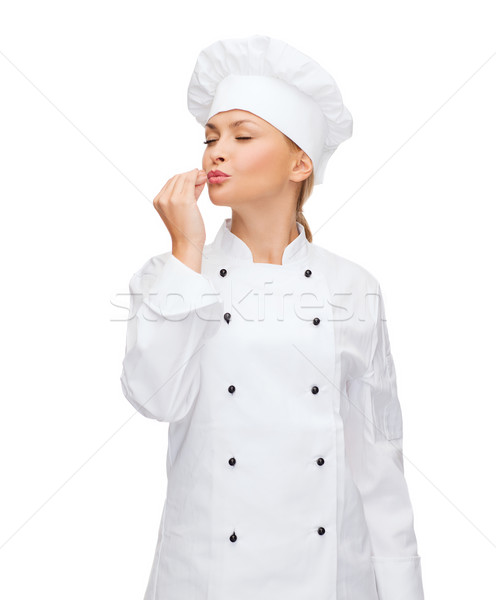 Stock photo: smiling female chef showing delicious sign