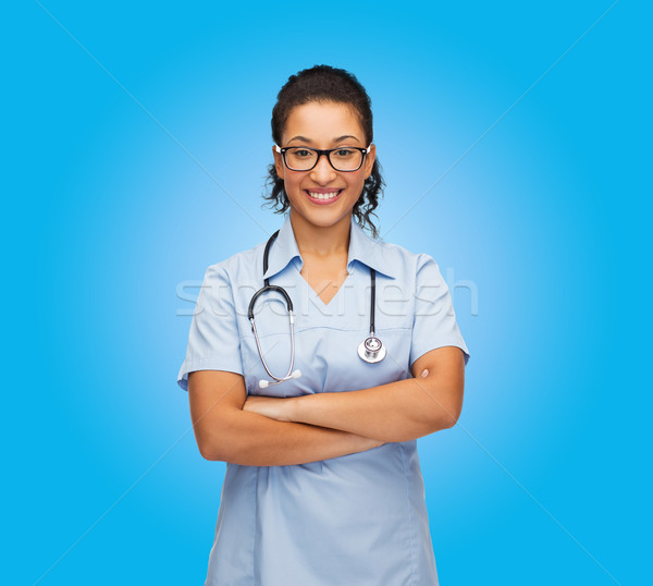 smiling female african american doctor or nurse Stock photo © dolgachov