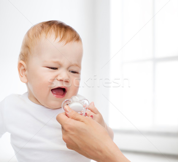 crying baby with dummy Stock photo © dolgachov