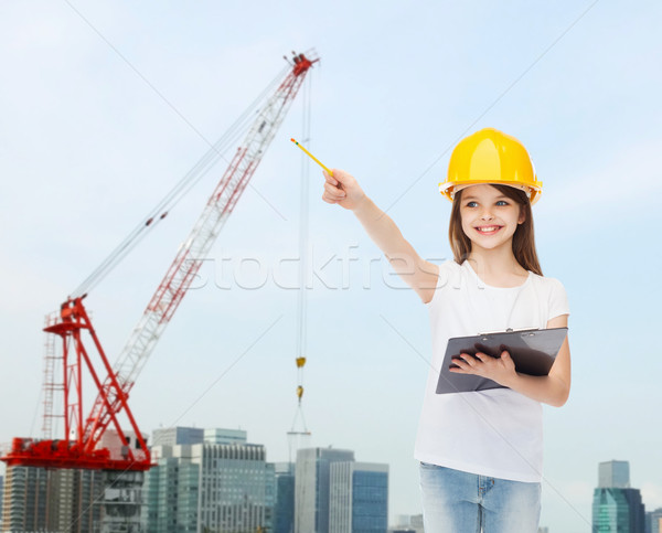 Sonriendo nina casco de seguridad portapapeles infancia construcción Foto stock © dolgachov