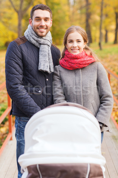Uśmiechnięty para baby wózki dla dzieci jesienią parku Zdjęcia stock © dolgachov