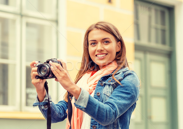 smiling girl with digiral photocamera in the city Stock photo © dolgachov