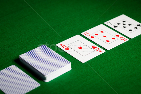 playing cards on green table surface Stock photo © dolgachov