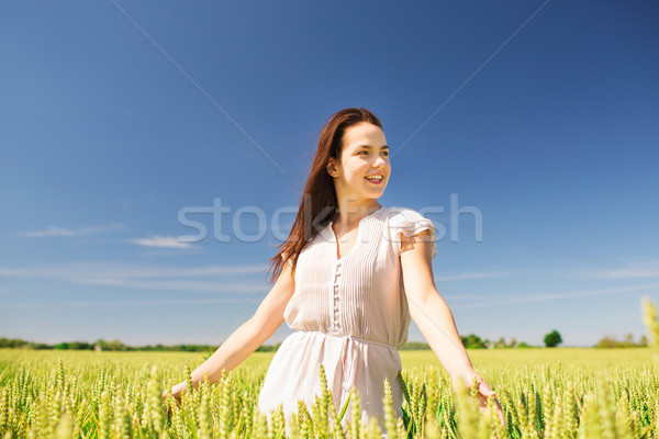 Stock photo: smiling young woman on cereal field