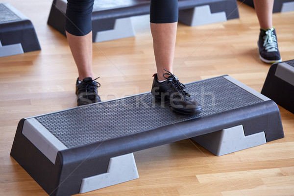 close up of women exercising with steppers in gym Stock photo © dolgachov