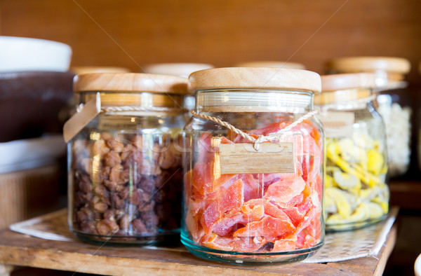close up of jars with dried fruits at grocery Stock photo © dolgachov
