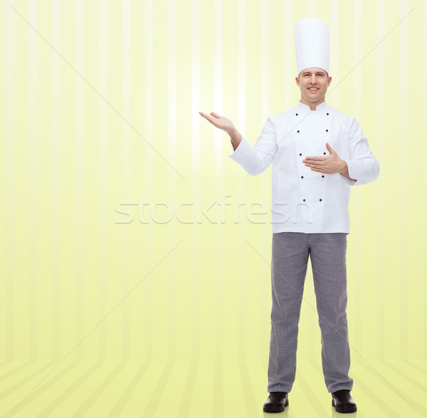happy male chef cook inviting Stock photo © dolgachov