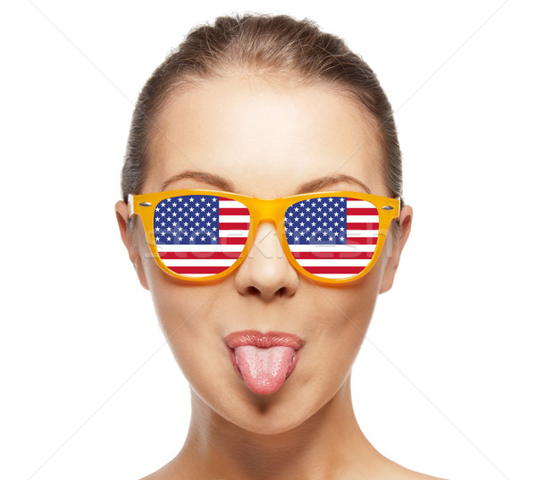 happy teenage girl in shades with american flag Stock photo © dolgachov