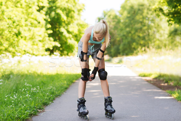 happy young woman in rollerskates riding outdoors Stock photo © dolgachov