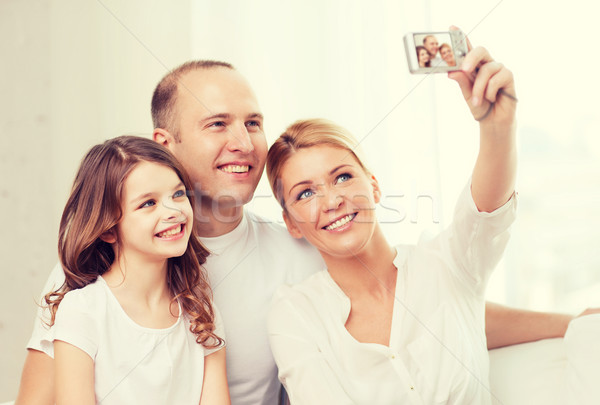 happy family with little girl making self portrait Stock photo © dolgachov