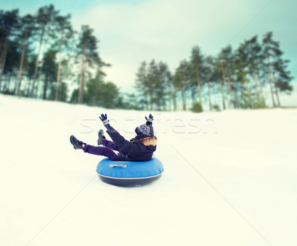 happy young man sliding down on snow tube Stock photo © dolgachov