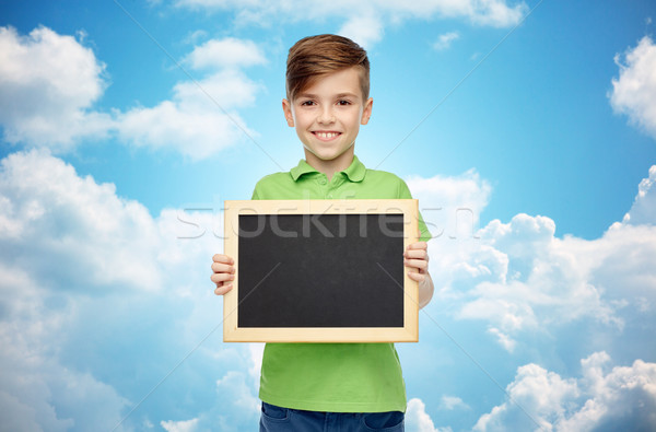 happy boy in t-shirt holding blank chalk board Stock photo © dolgachov