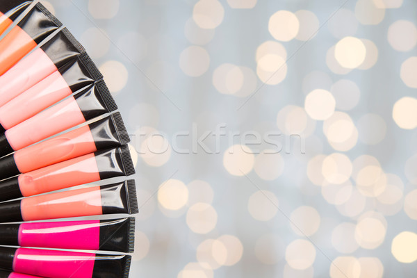 close up of lip gloss tubes over lights Stock photo © dolgachov
