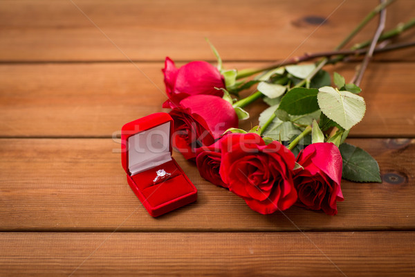 close up of diamond engagement ring and red roses Stock photo © dolgachov