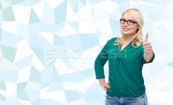 young woman in eyeglasses showing thumbs up Stock photo © dolgachov