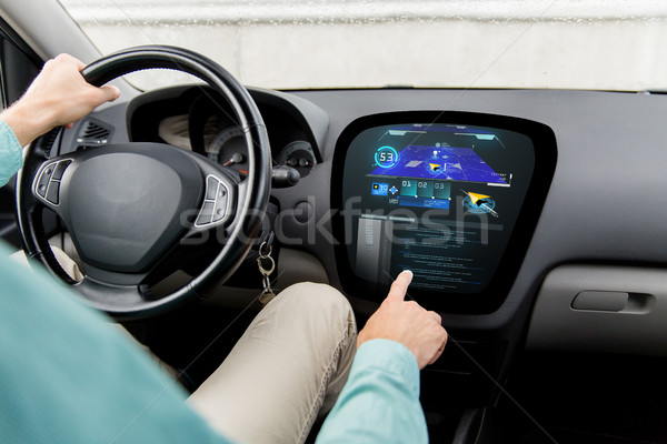 Stock photo: close up of man driving car with navigation system