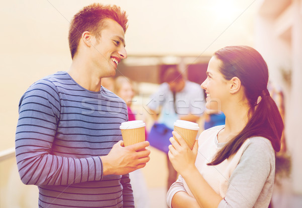 group of smiling students with paper coffee cups Stock photo © dolgachov