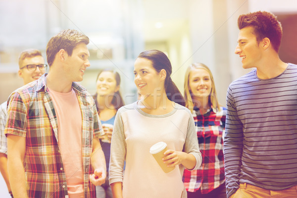 group of smiling students with paper coffee cups Stock photo © dolgachov