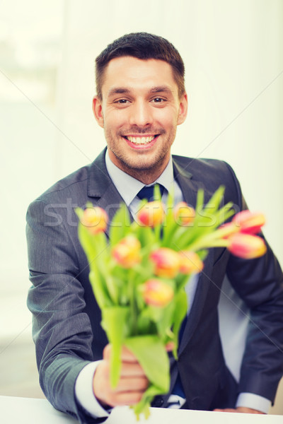 Lächelnd schöner Mann Bouquet Blumen Frühlingsblumen Glück Stock foto © dolgachov