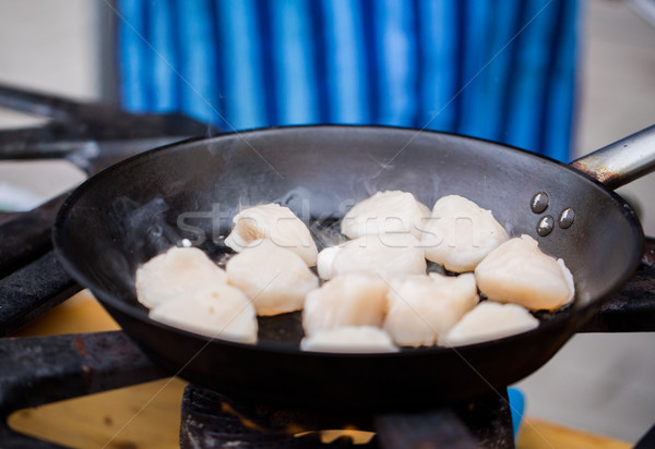 close up of scallops frying in cast iron pan Stock photo © dolgachov