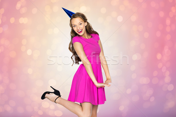 happy young woman or teen girl in party cap Stock photo © dolgachov