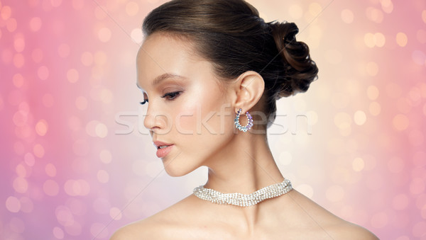 close up of beautiful woman face with earring Stock photo © dolgachov