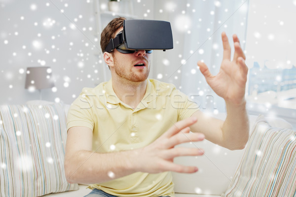 Stock photo: young man in virtual reality headset or 3d glasses