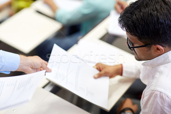 teacher giving exam test to student at lecture Stock photo © dolgachov