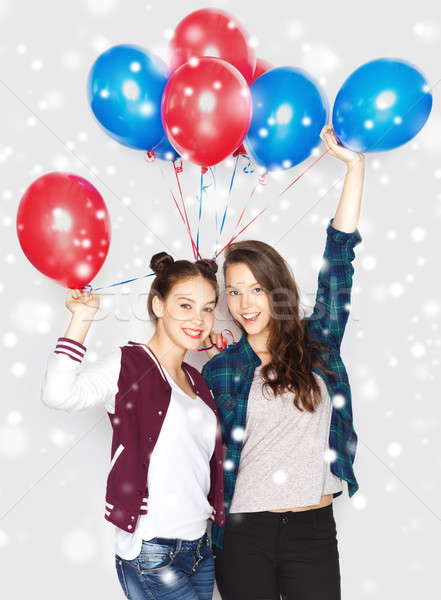 happy teenage girls with helium balloons over snow Stock photo © dolgachov