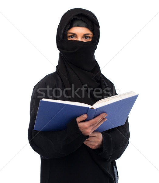 muslim woman in hijab reading book over white Stock photo © dolgachov