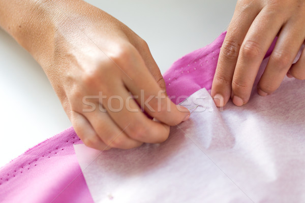 woman with pins stitching paper pattern to fabric Stock photo © dolgachov