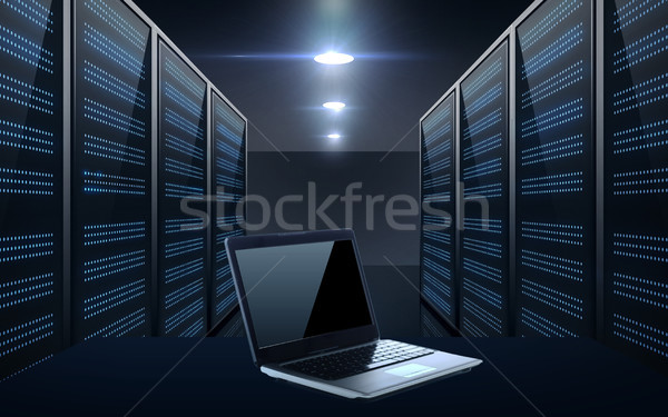 laptop computer over server room background Stock photo © dolgachov