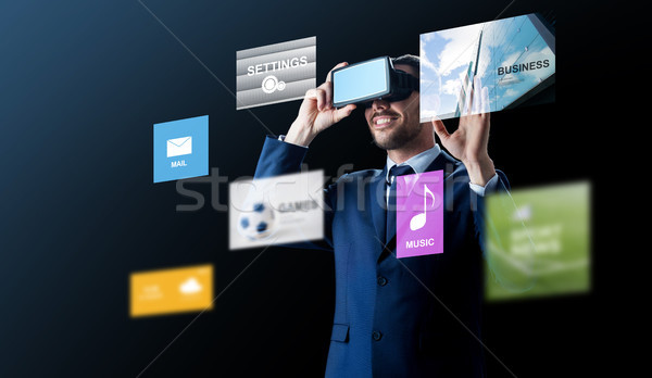 businessman in virtual reality headset over black Stock photo © dolgachov