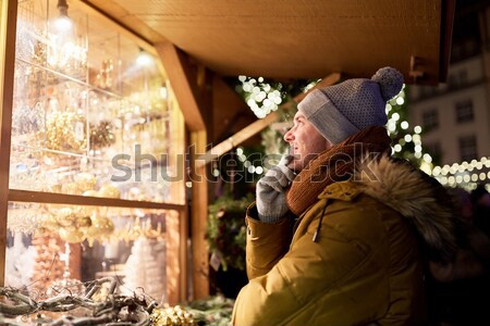 happy man looking at christmas market shop window Stock photo © dolgachov