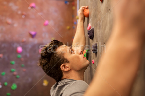 young man exercising at indoor climbing gym Stock photo © dolgachov