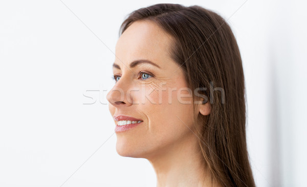 face of happy smiling middle aged woman Stock photo © dolgachov