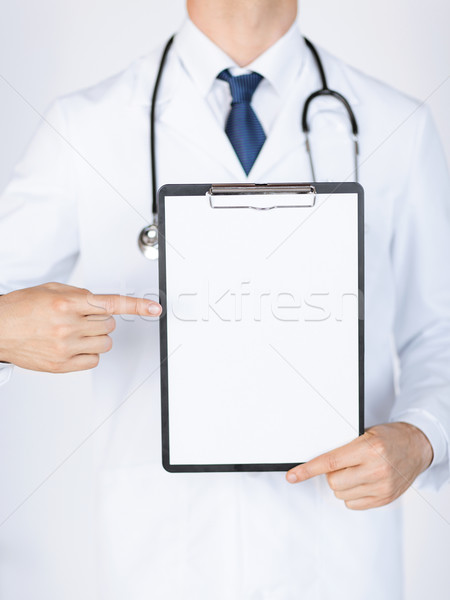 doctor pointing at blank white paper Stock photo © dolgachov