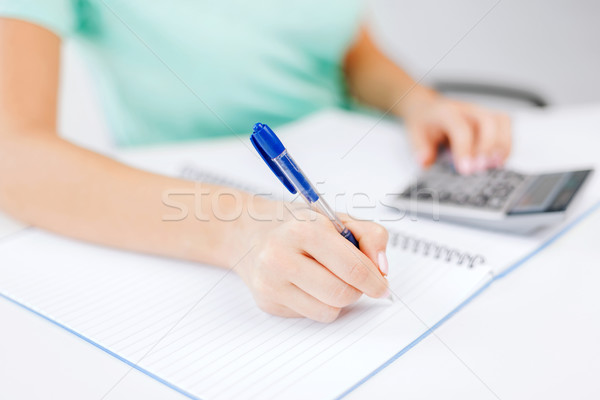 businesswoman working with calculator in office Stock photo © dolgachov