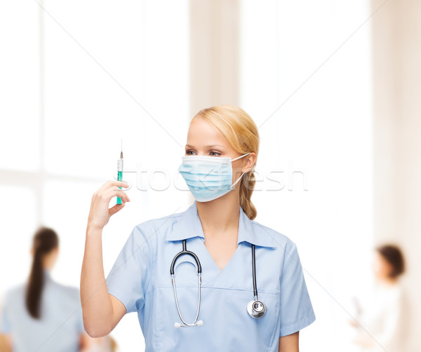 Femenino médico enfermera máscara jeringa Foto stock © dolgachov