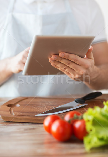 closeup of man pointing finger to tablet pc Stock photo © dolgachov
