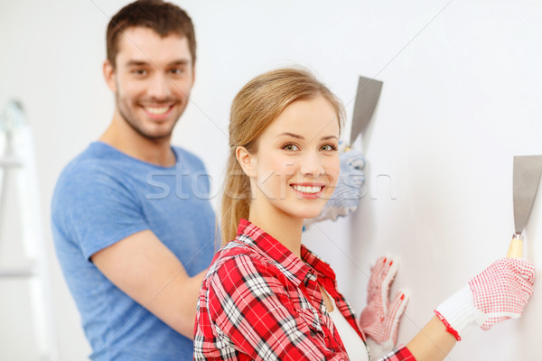 smiling couple doing renovations at home Stock photo © dolgachov