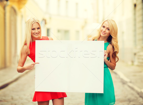 two happy blonde women with blank white board Stock photo © dolgachov