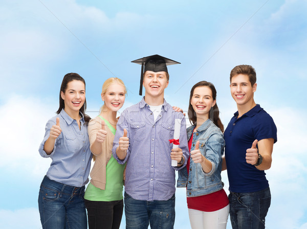 group of students with diploma showing thumbs up Stock photo © dolgachov