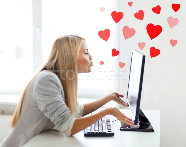 woman sending kisses with computer monitor Stock photo © dolgachov