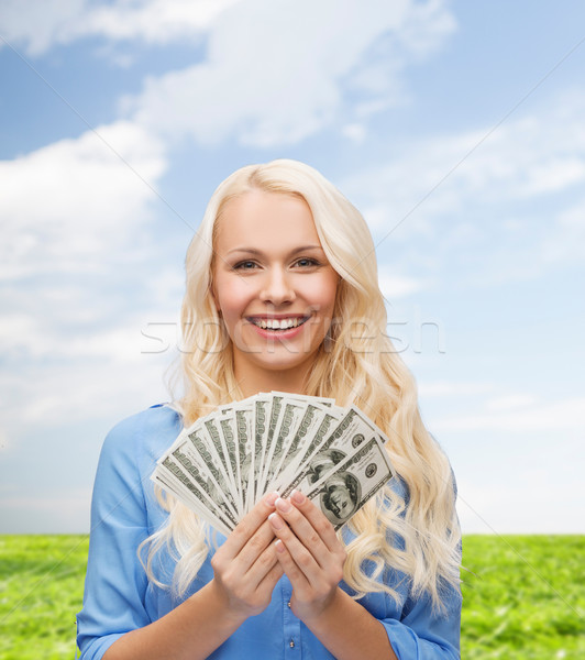 smiling young woman with us dollar money Stock photo © dolgachov
