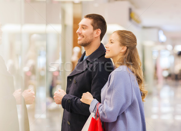 happy young couple with shopping bags in mall Stock photo © dolgachov