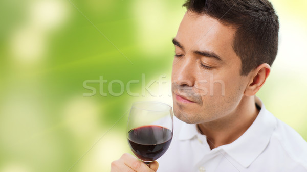 happy man drinking red wine from glass Stock photo © dolgachov