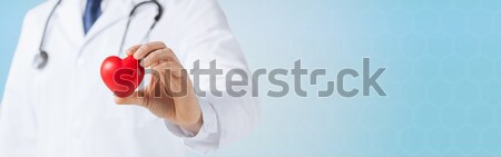 Közelkép férfi orvos kéz tart piros szív Stock fotó © dolgachov